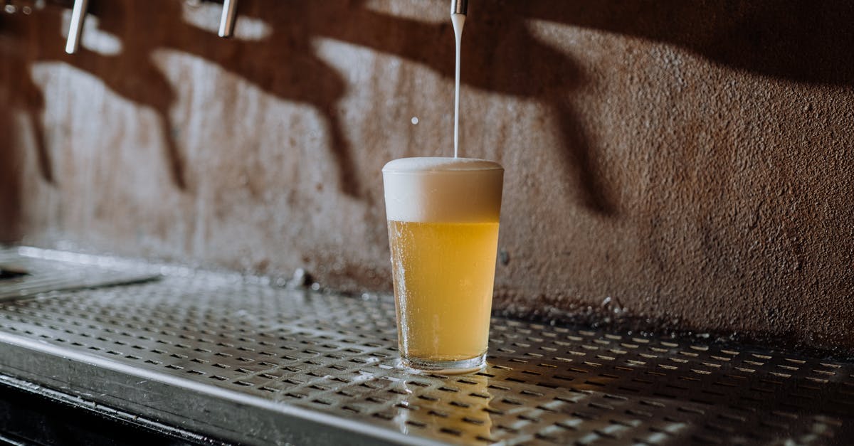 Is the pouring method of beer really important? - Beer Pouring Into Clear Drinking Glass on Metal Surface Is the pouring method of beer really important? - Beer Pouring Into Clear Drinking Glass on Metal Surface