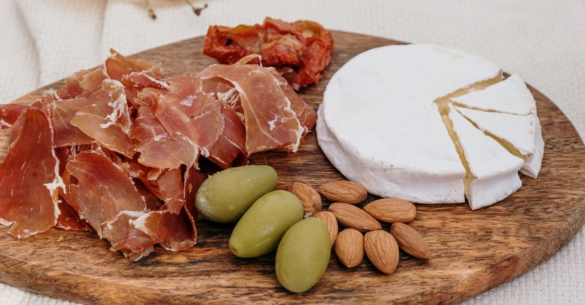Is there a difference between Brie & Camembert? - Sliced Meat on Brown Wooden Chopping Board