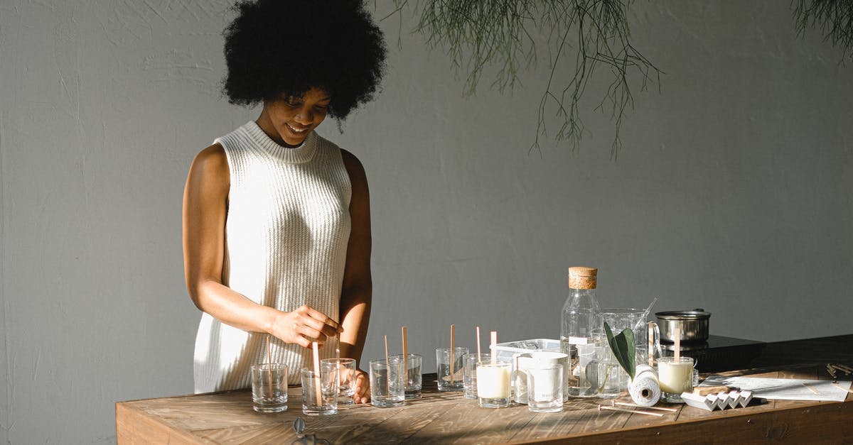 Is there a mold test kit for packaged food? - Positive African American female putting wooden wicks into candle molds while standing at wooden table with various equipment in light room Is there a mold test kit for packaged food? - Positive African American female putting wooden wicks into candle molds while standing at wooden table with various equipment in light room