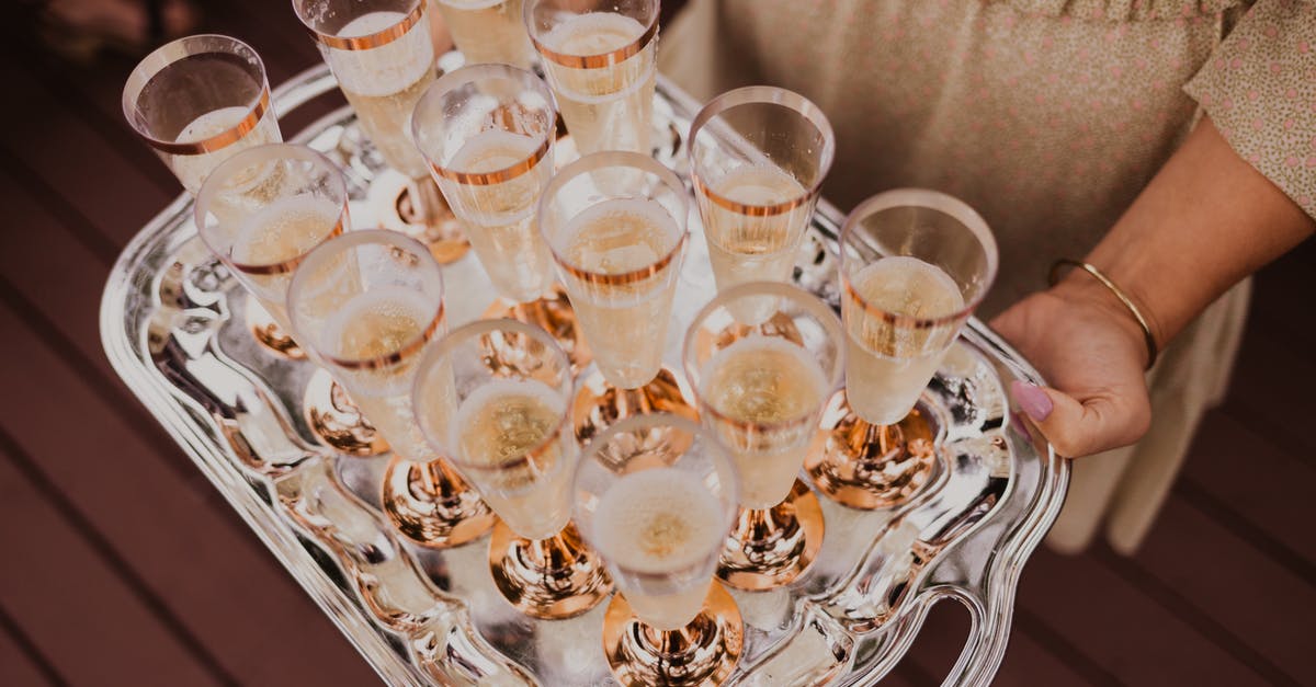 Is there a non-alcoholic beverage that has bubbles like champagne? - From above of crop female holding tray with glasses of champagne in daylight Is there a non-alcoholic beverage that has bubbles like champagne? - From above of crop female holding tray with glasses of champagne in daylight
