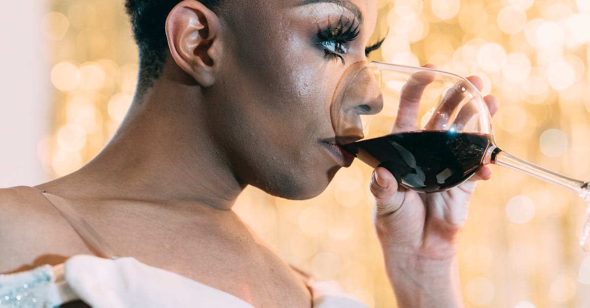 Is there a non-recipe specific, nonalcoholic, universal substitute for white wine? [duplicate] - Crop stylish transgende rmale in white outfit and with fancy bright makeup drinking red wine while looking away on glowing background