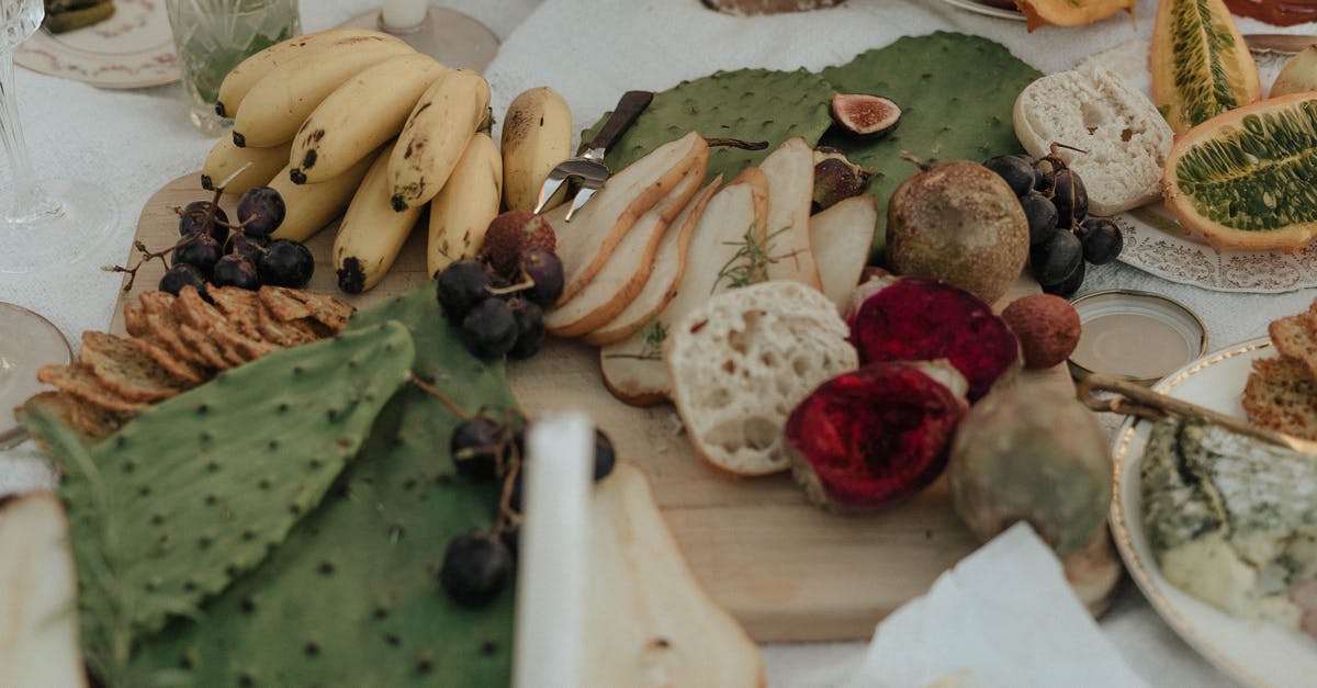 Is there a papaya substitute in salads? - From above of fresh fruit with snacks green opuntia and bread on white cloth for picnic