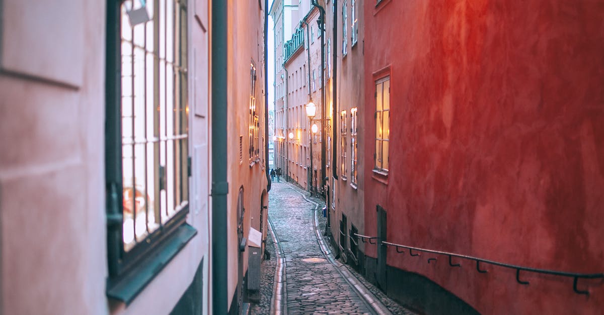 Is there a way to revive an old potato? - Narrow cobblestone pedestrian passage between old apartment buildings with burning electric lights in windows at twilight Is there a way to revive an old potato? - Narrow cobblestone pedestrian passage between old apartment buildings with burning electric lights in windows at twilight