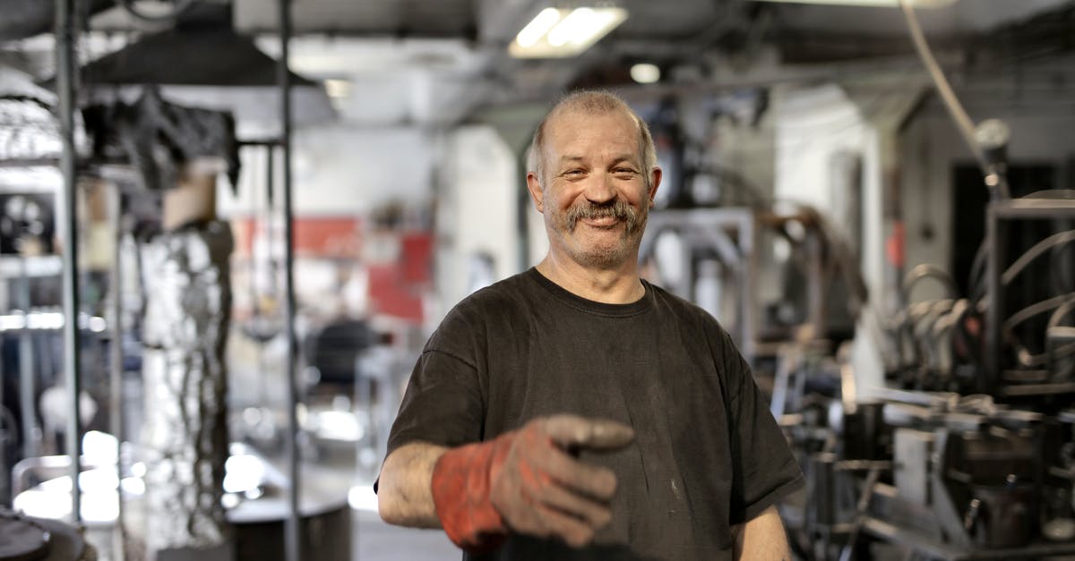 Is there an aging process by which to "oak" meat? - Cheerful senior white hair craftsman in heavy duty gloves laughing in workshop while looking at camera Is there an aging process by which to "oak" meat? - Cheerful senior white hair craftsman in heavy duty gloves laughing in workshop while looking at camera
