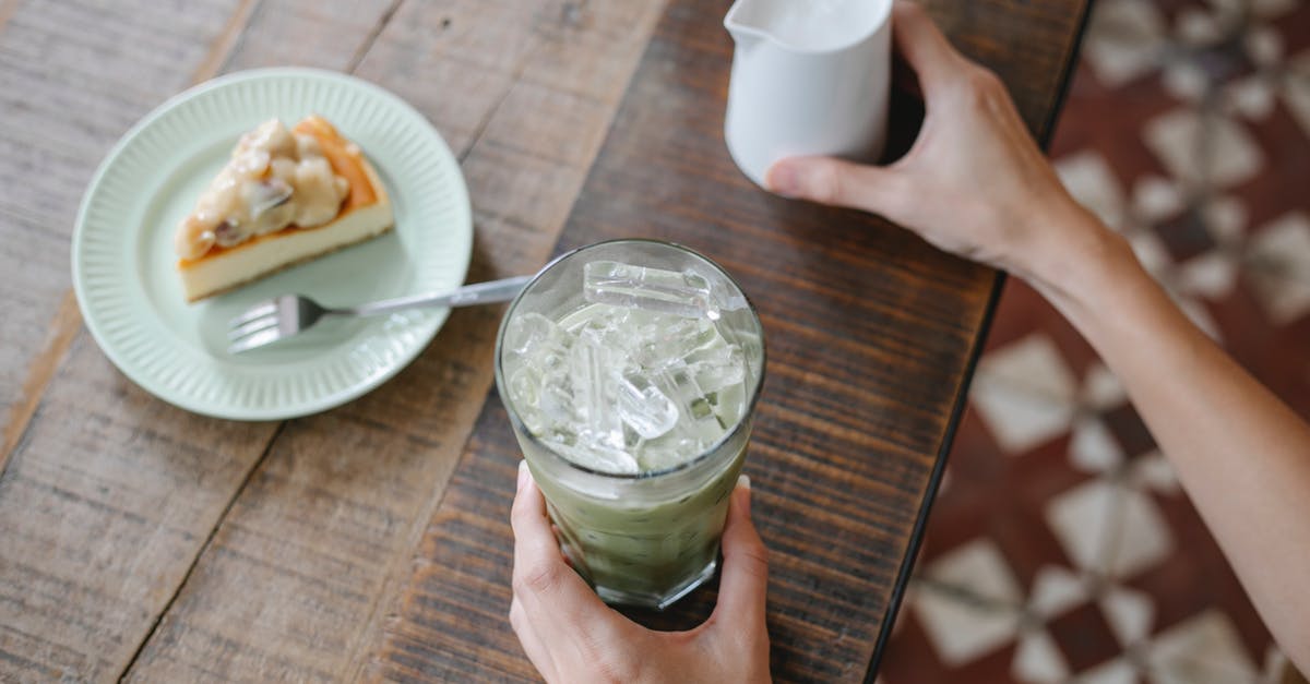 Is there an alternative to condensed milk? - From above crop anonymous female preparing delicious iced matcha latte while sitting at table with sweet pie Is there an alternative to condensed milk? - From above crop anonymous female preparing delicious iced matcha latte while sitting at table with sweet pie