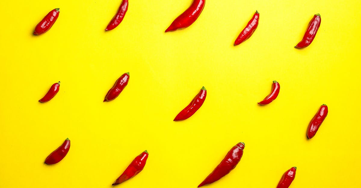 Is there any food ingredient that tastes like diesel smells? - Top view vibrant composition of spicy red chili peppers placed in rows on bright yellow background Is there any food ingredient that tastes like diesel smells? - Top view vibrant composition of spicy red chili peppers placed in rows on bright yellow background