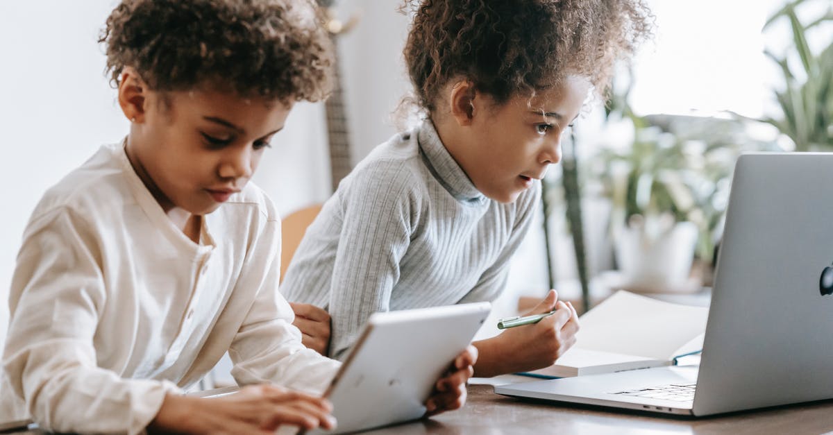Is there ever an advantage to using a light-bottomed pan? - Focused African American children in casual clothes sitting at table and browsing laptop and tablet at home in daytime Is there ever an advantage to using a light-bottomed pan? - Focused African American children in casual clothes sitting at table and browsing laptop and tablet at home in daytime