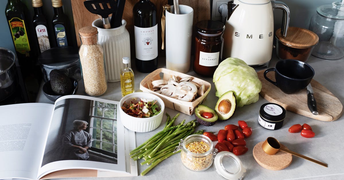 Is there something better than mineral oil for cutting boards? - Various colorful healthy food and vegetables locating on countertop next to many different utensils and white kettle during cooking in stylish kitchen