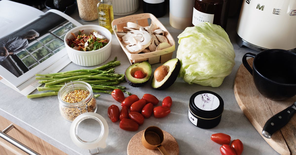 Is there something better than mineral oil for cutting boards? - From above of various organic vegetables chopped ingredients near cutting board kitchenware appliances and trendy magazine placed on gray countertop in kitchen at home