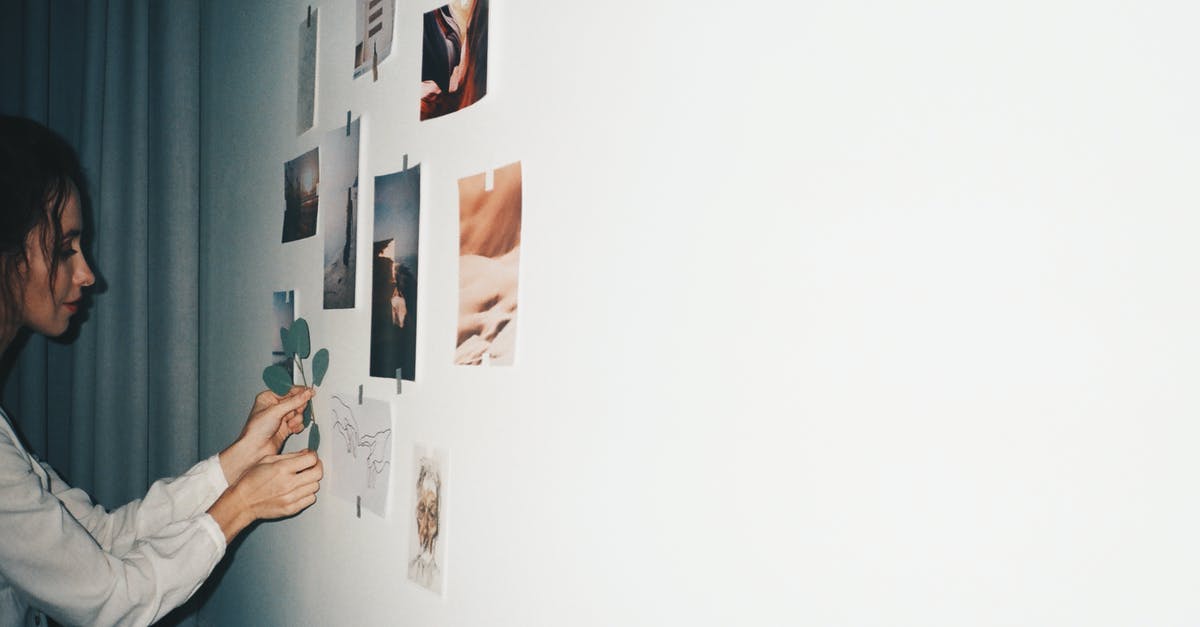 Is this kind of outlook in the wall inside an opened can looking normal? - Woman Putting Picture on White Wall Is this kind of outlook in the wall inside an opened can looking normal? - Woman Putting Picture on White Wall