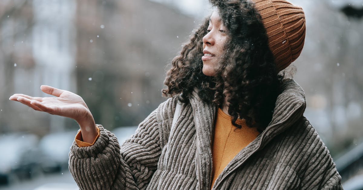 Is this some kind of warming oven? - Black woman catching snow in winter city Is this some kind of warming oven? - Black woman catching snow in winter city