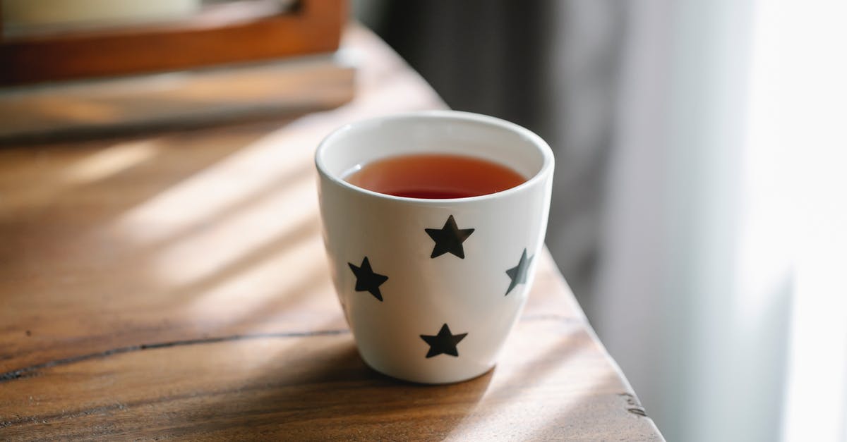 Is this white flaky powder in this tea "vanilla flavor"? - High angle of white ceramic cup with stars of hot tasty tea placed on wooden table Is this white flaky powder in this tea "vanilla flavor"? - High angle of white ceramic cup with stars of hot tasty tea placed on wooden table