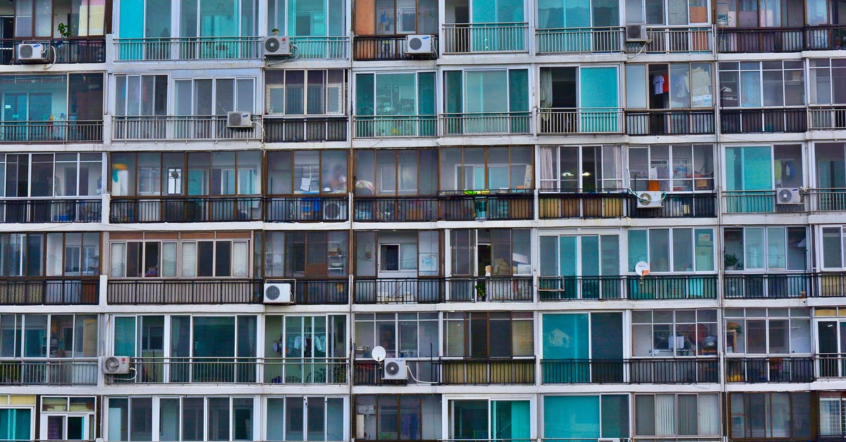 Is unnecessary refrigeration problematic? - Facade of contemporary residential multistage house with many apartments representing fenced terraces and windows near outdoor air conditioning units in town in daylight Is unnecessary refrigeration problematic? - Facade of contemporary residential multistage house with many apartments representing fenced terraces and windows near outdoor air conditioning units in town in daylight