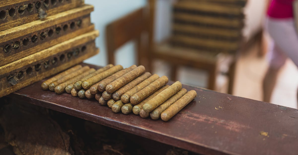Is very slow smoking of meat allowed commercially in the US? - Production of raw cigars on wooden table in fabric