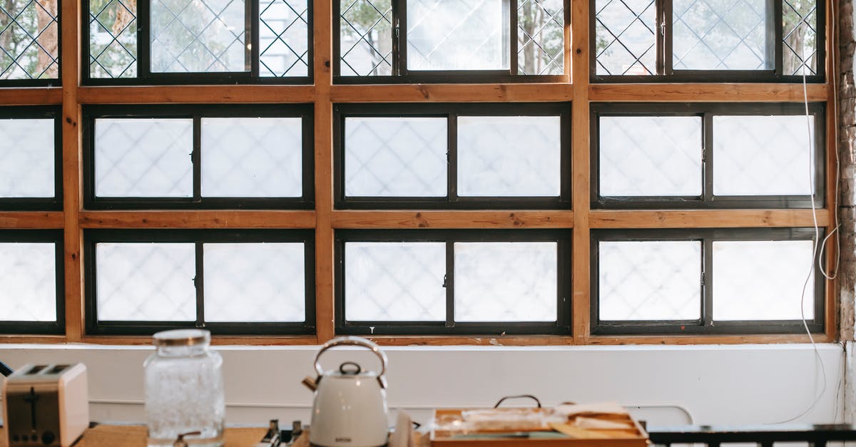 Is water on the outside of an electric kettle dangerous? - Kitchen interior with fenced window near table with electric appliances and bottle of water with tap in house Is water on the outside of an electric kettle dangerous? - Kitchen interior with fenced window near table with electric appliances and bottle of water with tap in house