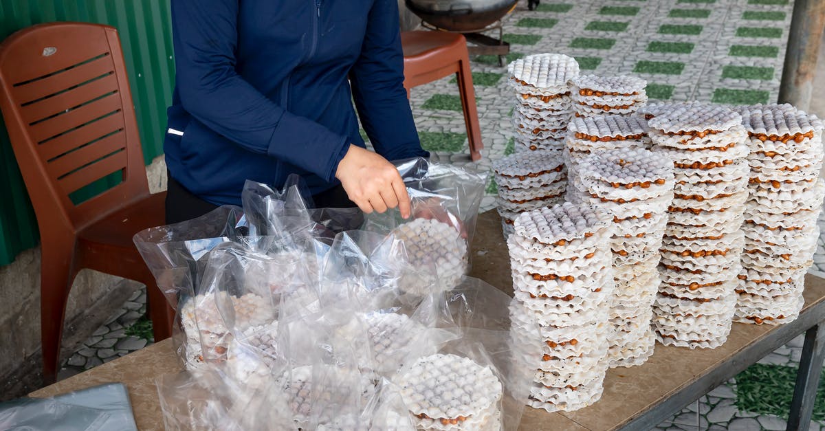 Is white rice bleached before being processed? - Crop vendor packing rice cakes at table Is white rice bleached before being processed? - Crop vendor packing rice cakes at table