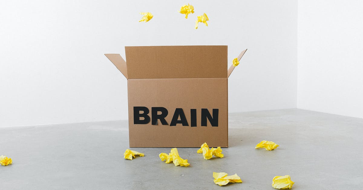 Isi cream whipper head valve sticks open - Crumpled yellow paper pieces on floor near carton box with Brain title on white background Isi cream whipper head valve sticks open - Crumpled yellow paper pieces on floor near carton box with Brain title on white background
