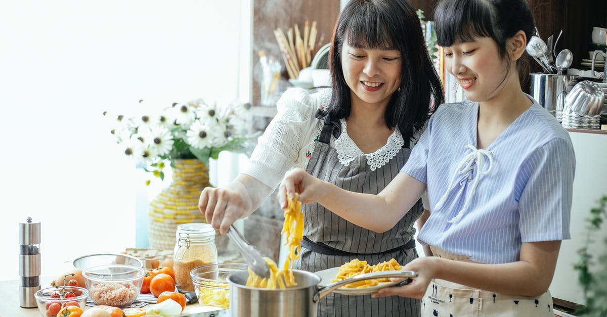 Italian Meringue Help - Sticking to Mixer - Happy mother and daughter cooking homemade long noodles in saucepan on electric hob in kitchen Italian Meringue Help - Sticking to Mixer - Happy mother and daughter cooking homemade long noodles in saucepan on electric hob in kitchen