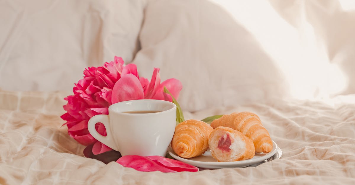 Jam stored in hot temperatures - Cup of fresh aromatic coffee with plate of yummy croissants with berry jam placed on soft bed with gentle peony in sunny morning Jam stored in hot temperatures - Cup of fresh aromatic coffee with plate of yummy croissants with berry jam placed on soft bed with gentle peony in sunny morning