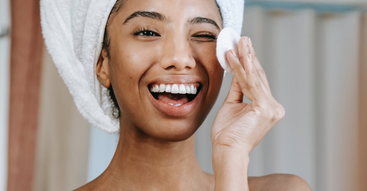 Japanese Cotton Sponge Cake - How to stop collapsing? - Delighted ethnic woman laughing brightly while looking at reflection and cleaning face with cotton pad in morning Japanese Cotton Sponge Cake - How to stop collapsing? - Delighted ethnic woman laughing brightly while looking at reflection and cleaning face with cotton pad in morning
