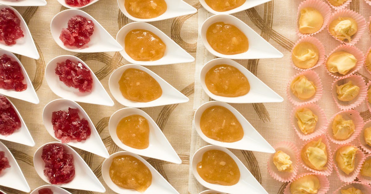 Jelly or flavored Gelatin - Red and Yellow Jam in White Ceramic Plates and Pastry Jelly or flavored Gelatin - Red and Yellow Jam in White Ceramic Plates and Pastry