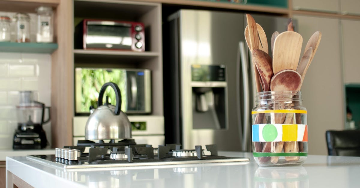 Keeping an aluminium dish in a convection microwave - Cozy kitchen with wooden utensil at home Keeping an aluminium dish in a convection microwave - Cozy kitchen with wooden utensil at home