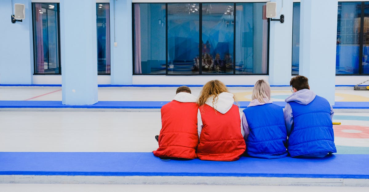 Keeping crushed ice from melting, without it joining back together - Unrecognizable people sitting on floor together Keeping crushed ice from melting, without it joining back together - Unrecognizable people sitting on floor together