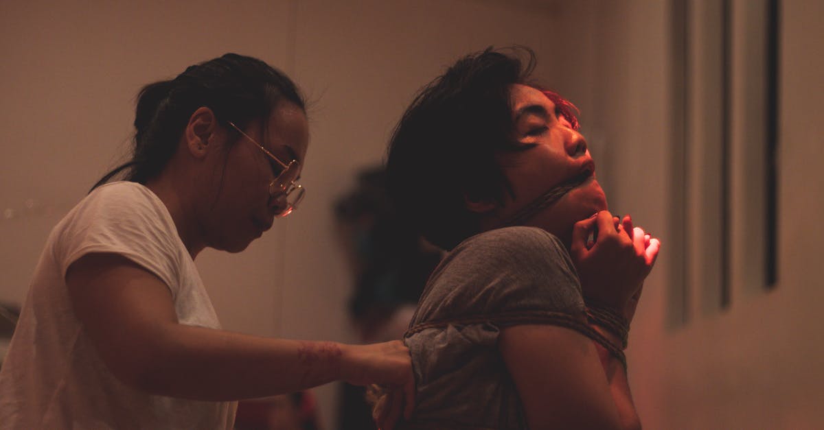 Keeping crushed ice from melting, without it joining back together - Ethnic woman performing ancient rite win young tied man indoors Keeping crushed ice from melting, without it joining back together - Ethnic woman performing ancient rite win young tied man indoors