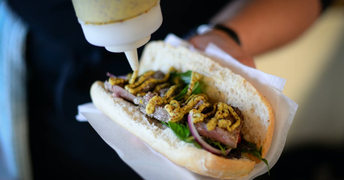 Keeping Hot Sauce From Separating - Cook putting sauce to sandwich with meat Keeping Hot Sauce From Separating - Cook putting sauce to sandwich with meat