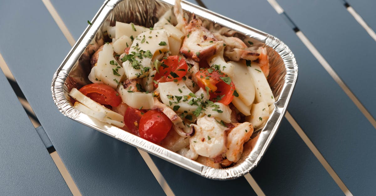 Keeping Hot Sauce From Separating - From above of tasty squids with tomatoes and herbs under sauce in foil container on blue metal table Keeping Hot Sauce From Separating - From above of tasty squids with tomatoes and herbs under sauce in foil container on blue metal table