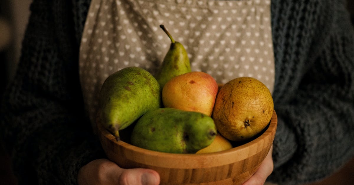 Keeping ripe pears for canning later - Person Holding a Wooden Bowl of Fresh Fruits Keeping ripe pears for canning later - Person Holding a Wooden Bowl of Fresh Fruits