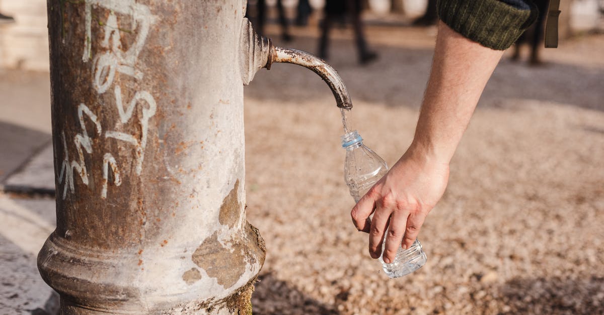 Kefir sensitivity to drinking tap water? - Crop person filling bottle with water from drinking fountain Kefir sensitivity to drinking tap water? - Crop person filling bottle with water from drinking fountain