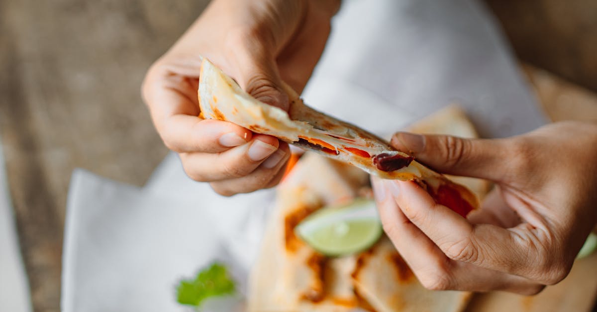 Key Lime Pie Filling - Thins out after pumping - Person Holding a Sliced Tortilla Wrap with Filling Key Lime Pie Filling - Thins out after pumping - Person Holding a Sliced Tortilla Wrap with Filling