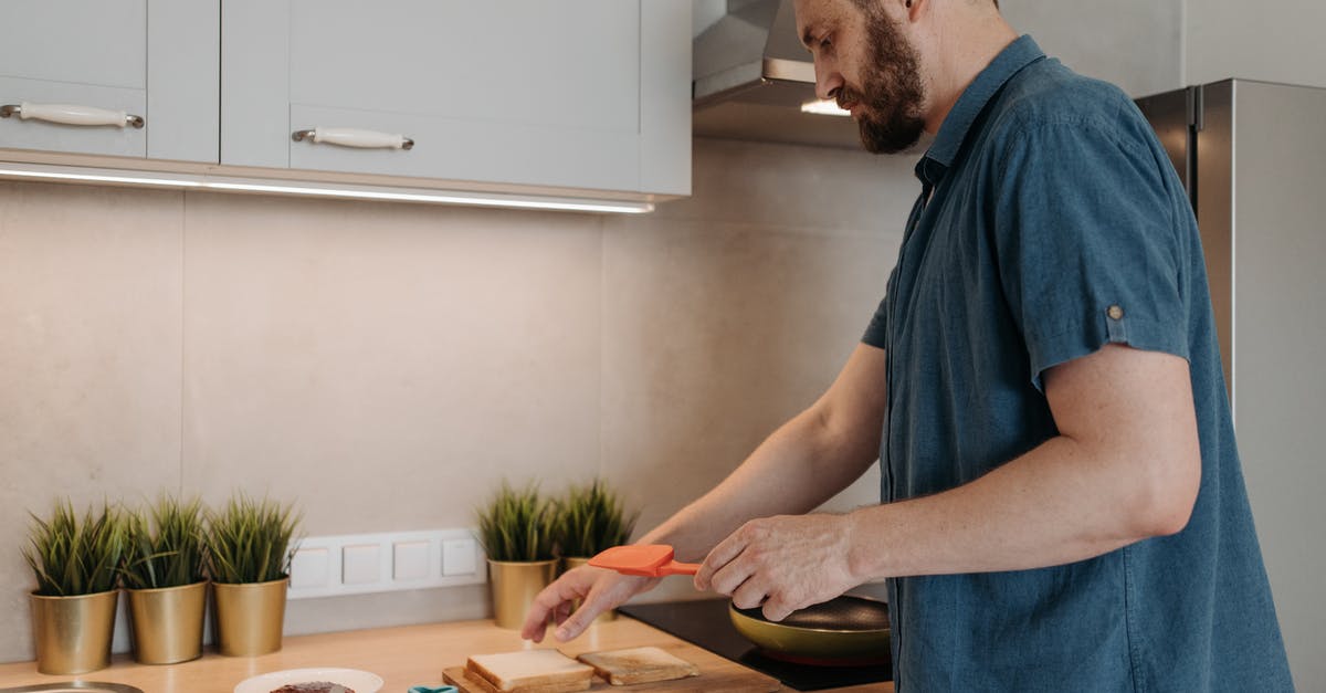 Lasagna in a sandwich maker - Man in Blue Crew Neck T-shirt Standing in Front of Brown Wooden Table Lasagna in a sandwich maker - Man in Blue Crew Neck T-shirt Standing in Front of Brown Wooden Table
