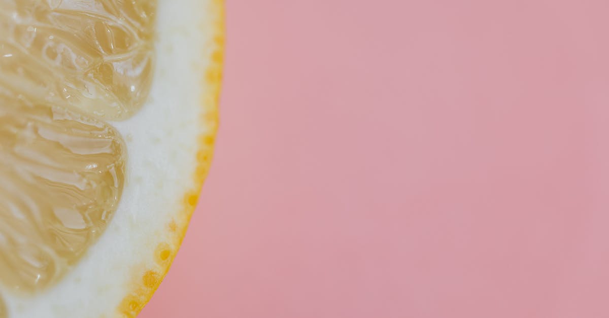 Lemon peel thickness - Top view flat lay composition of sliced lemon placed on pink background Lemon peel thickness - Top view flat lay composition of sliced lemon placed on pink background