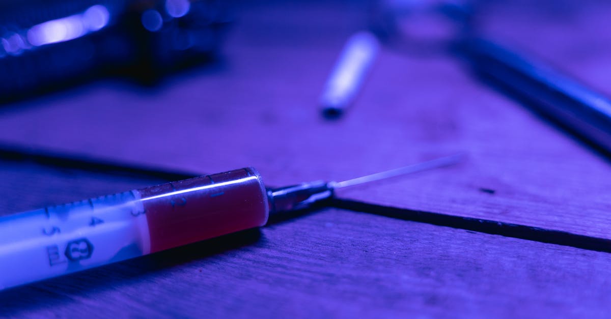 Liquid sloshing around in vacuum-packed mussels? - A Syringe with Brown Chemical on a Wooden Table Liquid sloshing around in vacuum-packed mussels? - A Syringe with Brown Chemical on a Wooden Table