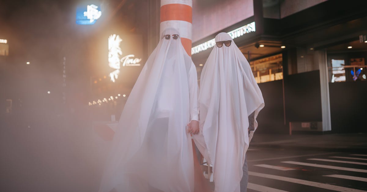 Lobster, steamed Saturday afternoon, eaten Monday night? - Anonymous couple wearing ghost costumes and sunglasses holding hands while standing near steam pipe and building in night city during Halloween Lobster, steamed Saturday afternoon, eaten Monday night? - Anonymous couple wearing ghost costumes and sunglasses holding hands while standing near steam pipe and building in night city during Halloween