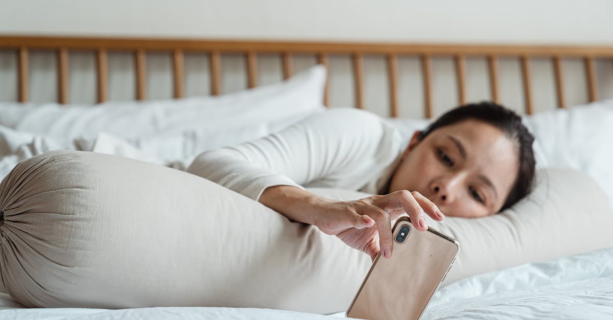 Long chilling of brioche dough? - Content young ethnic female watching video on cellphone while lying on comfortable bed with long cylinder pillow in morning and enjoying free time Long chilling of brioche dough? - Content young ethnic female watching video on cellphone while lying on comfortable bed with long cylinder pillow in morning and enjoying free time