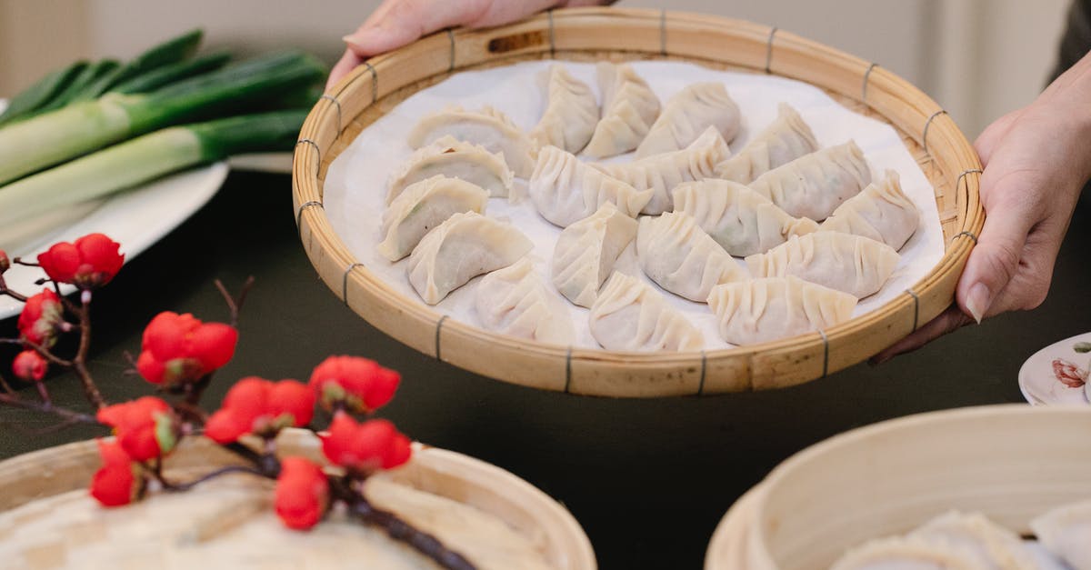 Looking for 10" bamboo steamer that will last! - Crop woman with delicious dumplings in bamboo tray at home Looking for 10" bamboo steamer that will last! - Crop woman with delicious dumplings in bamboo tray at home