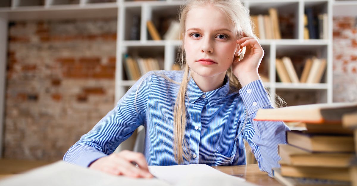 Looking for a Blue Ingredient - Woman Sitting Next to Table and Right Hand on Ear Looking for a Blue Ingredient - Woman Sitting Next to Table and Right Hand on Ear