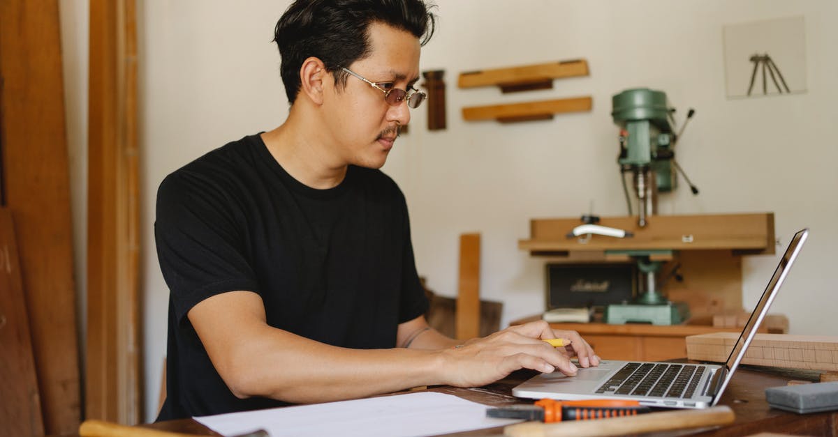 Looking for a pliers-like tool for making crushed tomatoes - Concentrated Asian male in glasses sitting at table with various equipment and browsing netbook during work day Looking for a pliers-like tool for making crushed tomatoes - Concentrated Asian male in glasses sitting at table with various equipment and browsing netbook during work day