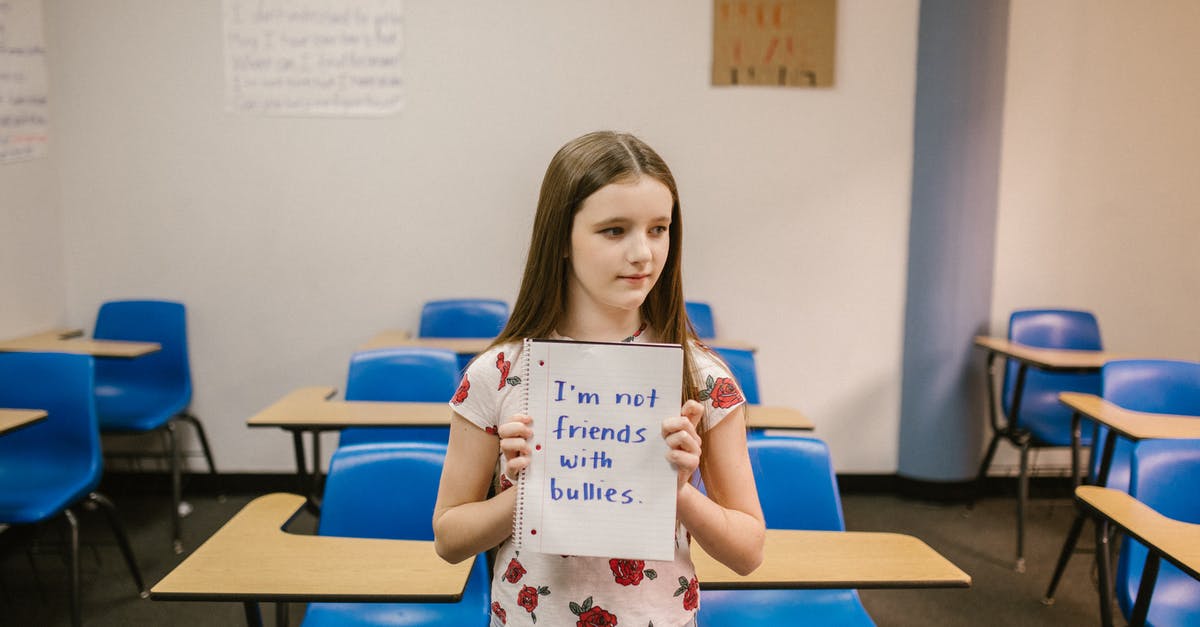 Looking for Rubbermaid "Servin' Saver™" container - Girl Showing a Message Against Bullying Written in a Notebook Looking for Rubbermaid "Servin' Saver™" container - Girl Showing a Message Against Bullying Written in a Notebook