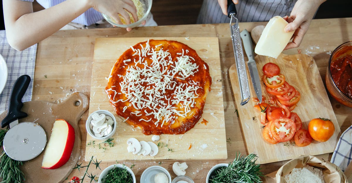 Looking to add some texture to my tomato soup recipe - Crop women adding cheese on pizza Looking to add some texture to my tomato soup recipe - Crop women adding cheese on pizza