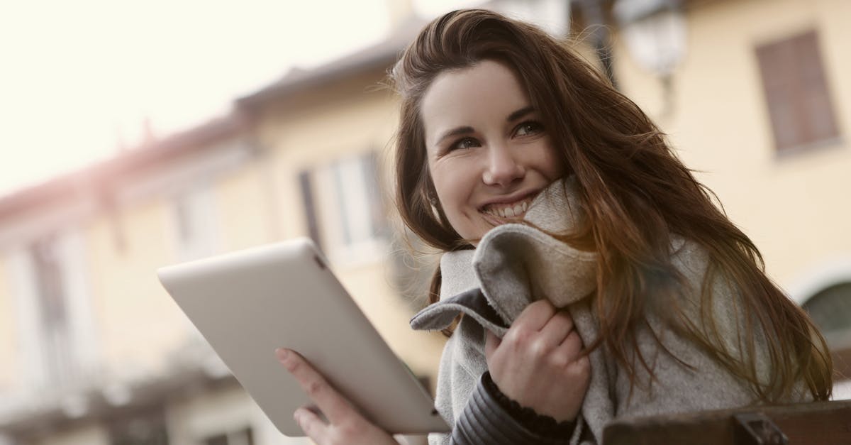 Low tech strategies for keeping food warm - Smiling woman messaging on tablet in city Low tech strategies for keeping food warm - Smiling woman messaging on tablet in city
