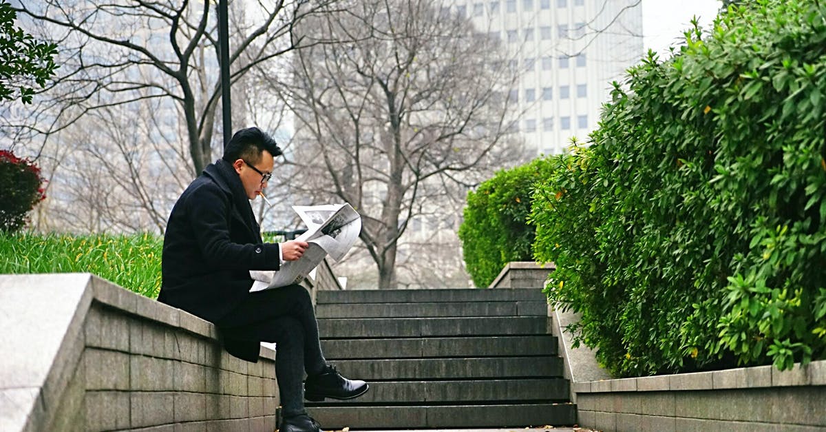 Mackerel brining time before smoking - Man Reading Newspaper Sitting on Stair Wall Mackerel brining time before smoking - Man Reading Newspaper Sitting on Stair Wall