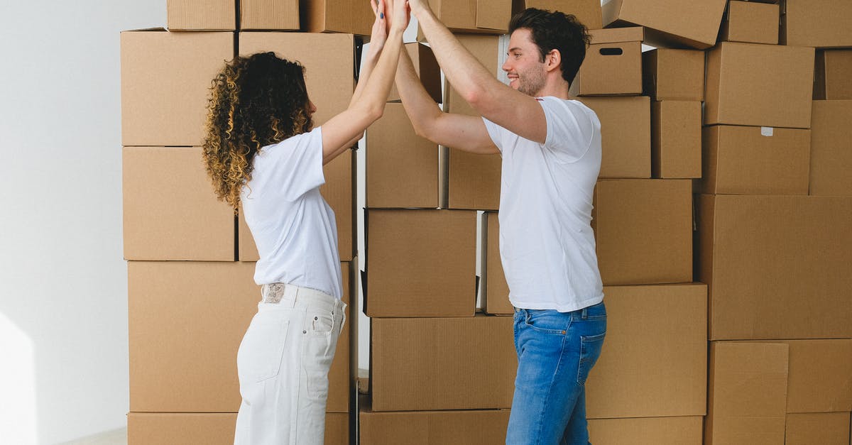 Mackerel, how to get the good stuff? - Smiling couple giving high five after moving into new house Mackerel, how to get the good stuff? - Smiling couple giving high five after moving into new house