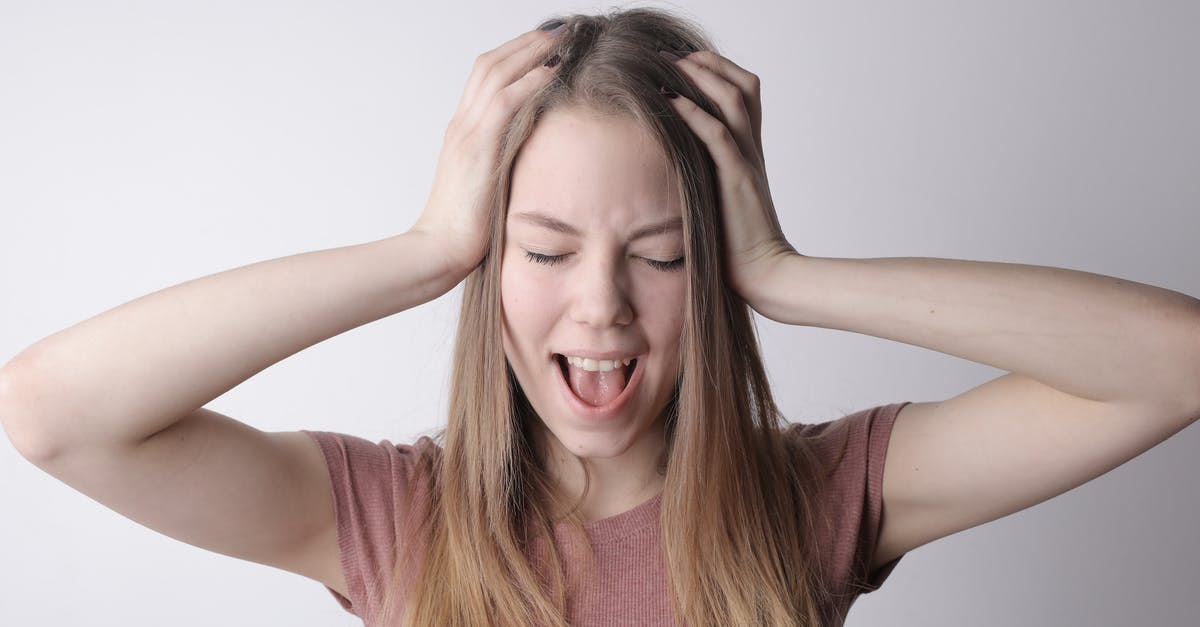 Maillard Reaction at Higher Pressures - Angry crazy female in casual pink t shirt touching head while being unhappy and shouting loudly against gray wall background Maillard Reaction at Higher Pressures - Angry crazy female in casual pink t shirt touching head while being unhappy and shouting loudly against gray wall background