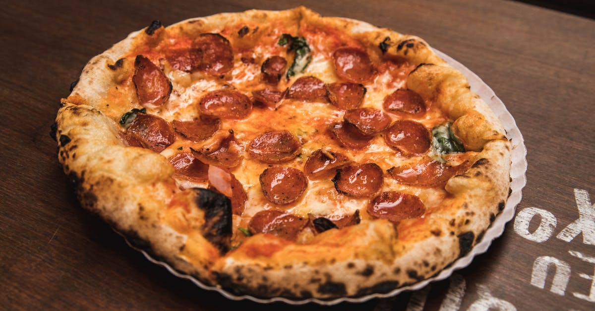 Make Pepperoni out of Regular Salami - Pizza on Brown Wooden Table Make Pepperoni out of Regular Salami - Pizza on Brown Wooden Table