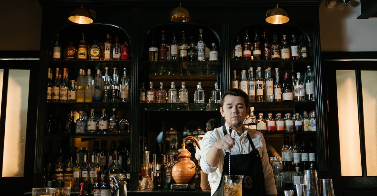 Making a better caramel for granola bar - Man in White Dress Shirt Sitting on Chair in Front of Bar Counter Making a better caramel for granola bar - Man in White Dress Shirt Sitting on Chair in Front of Bar Counter
