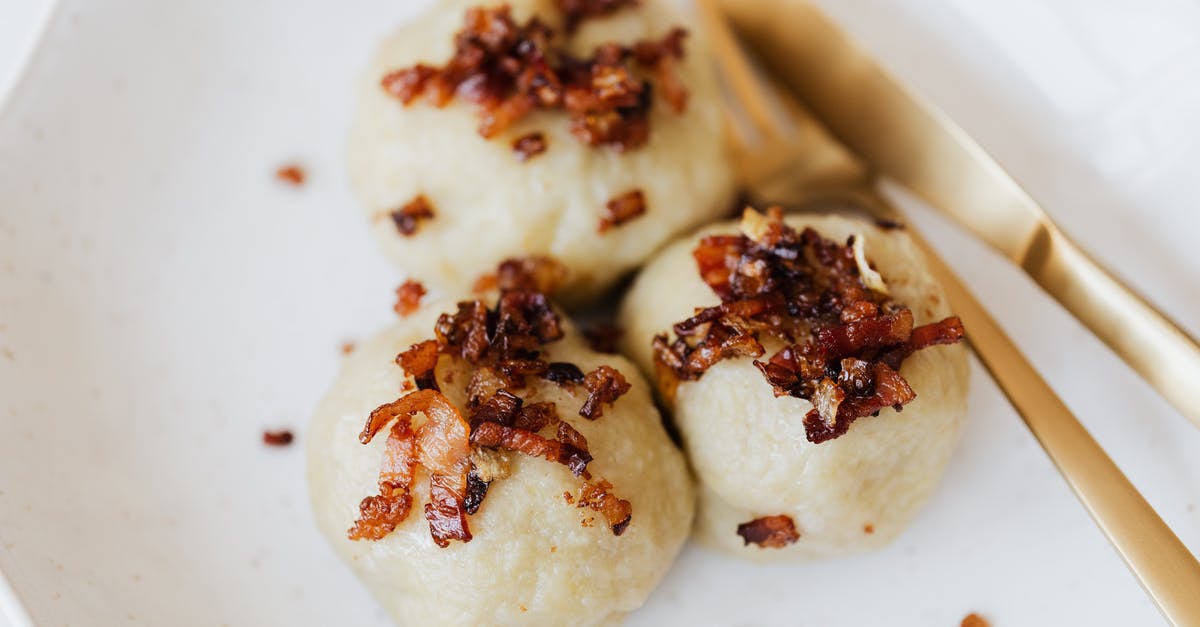 Making a test tiny roast - Lithuanian cepelinai with fried bacon on plate